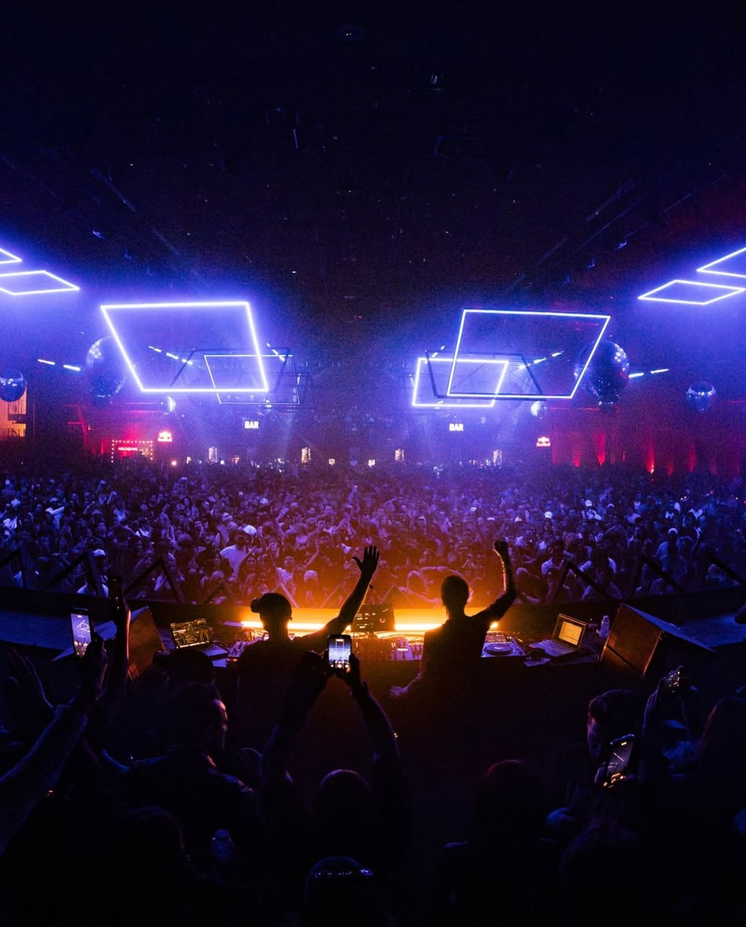 Kinetic lighting installation glowing above a crowd at RE:FRAME in Los Angeles